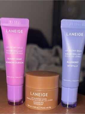 Laneige lip glowy balm in blueberry and gummy bear and chocolate sleeping mask.